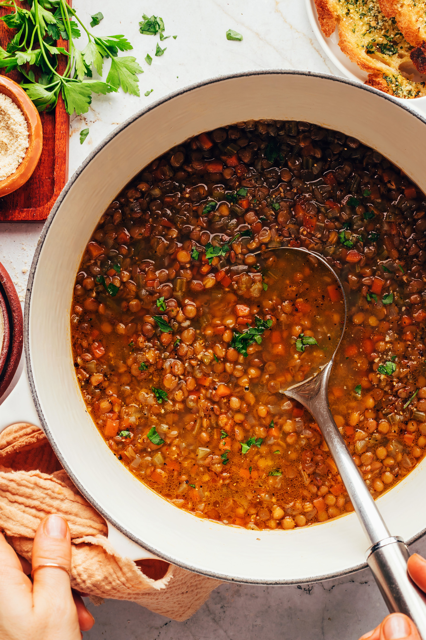 Ladle in a Dutch oven with a batch of our Italian lentil soup recipe