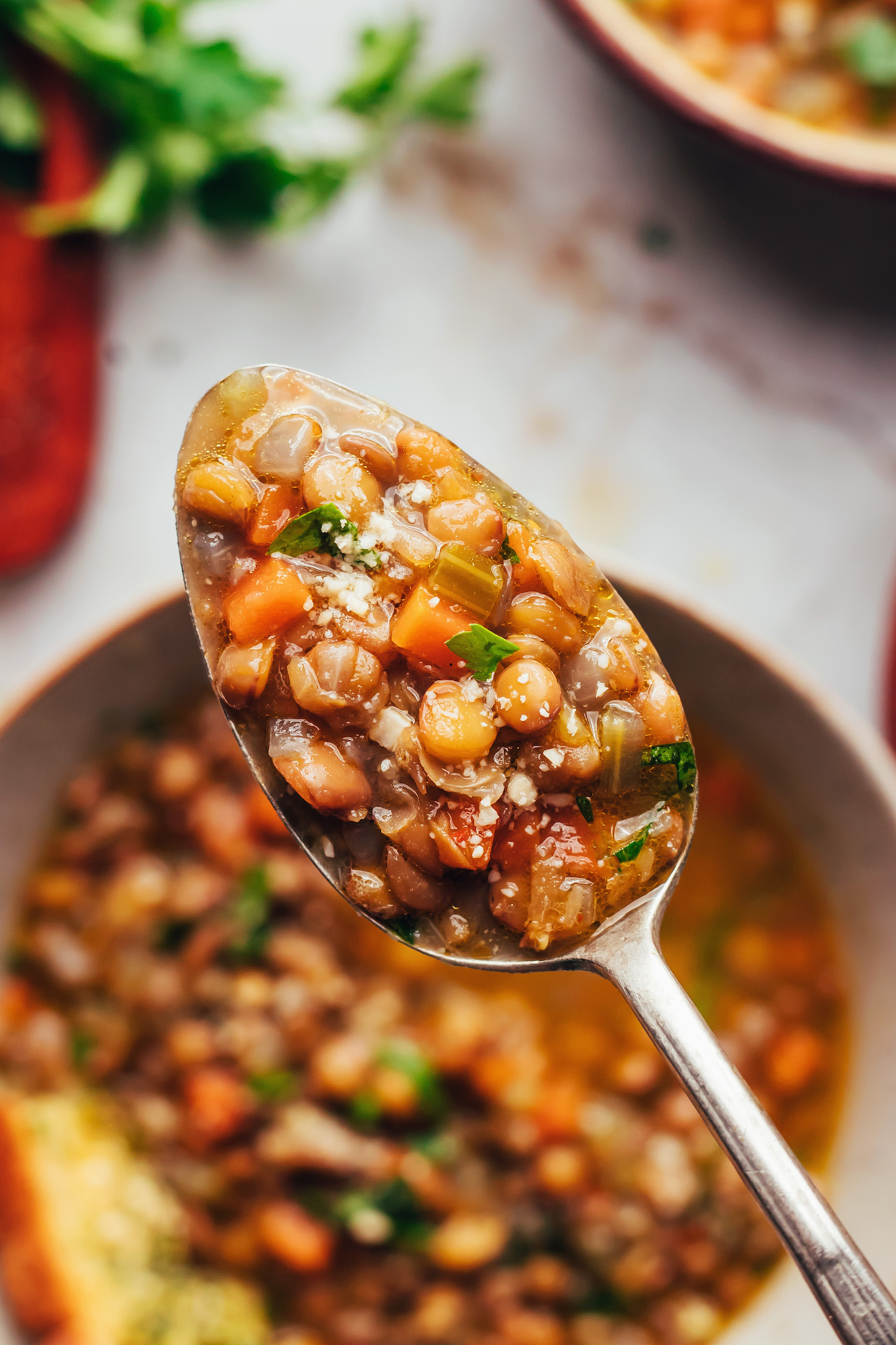 Close up photo of a spoonful of Italian lentil soup (zuppa di lenticchie)