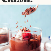 Sprinkling shaved dark chocolate over a dessert glass of chocolate sweet potato pot de creme