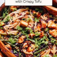 Large wooden serving bowl of our Vegan Ginger Sesame Noodles with Crispy Tofu